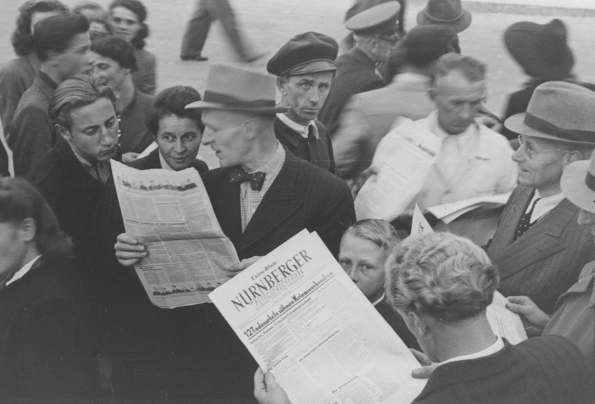 People gather to read a special edition of the Nürnberger newspaper reporting the sentences handed down by the International Military Tribunal, 1 October 1946. US Holocaust Memorial Museum, courtesy of Gerald Schwab. People gather to read a special edition of the Nürnberger newspaper reporting the sentences handed down by the International Military Tribunal, 1 October 1946. US Holocaust Memorial Museum, courtesy of Gerald Schwab.